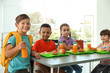 © New Africa - Children sitting at table and eating healthy food during break at school