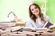 © Elnur - Young female student preparing for exams with many books