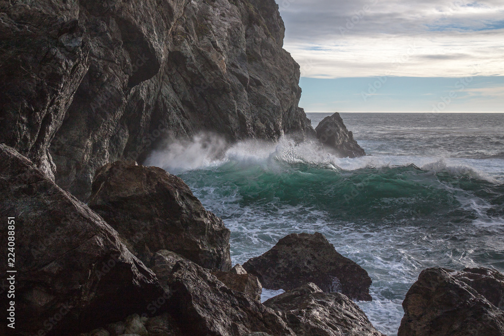 Waves crashing against the rocky shore Stock Photo | Adobe Stock