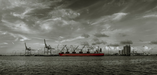 storm clouds move over a ship docked in the port panorama