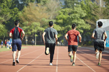 Young Asian Athletes Running On Track