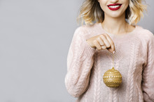 Young Woman With Christmas Ball In Hand