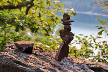 Wall Mural - beautiful wisconsin nature background. scenic view with stones pyramid on a lake background in blur 