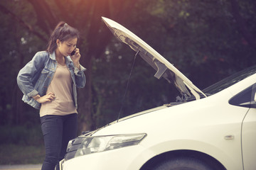 Wall Mural - Young woman with broken car calling for help.Vintage color