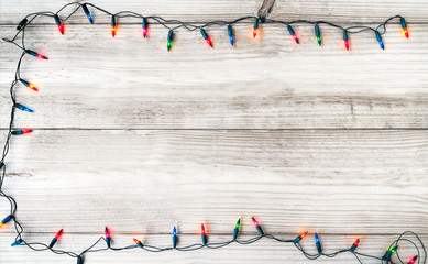 Wall Mural - christmas lights bulb decoration on white wood plank. merry christmas and new year holiday backgroun