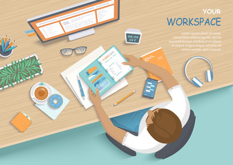 Man sitting at the wooden table. Workplace Desktop Workspace Armchair, office supplies, monitor, books, notebook, headphones, phone, glasses, pen, paper, tea, donuts. Vector Top view 