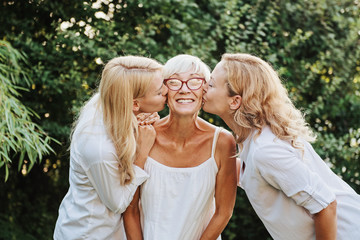 Three women enjoying outdoors, talking and laughing 