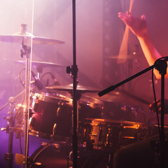 Wall Mural - Hand with drumsticks near rock drum set