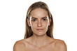 Portrait of young beautiful shirtless woman with no makeup on white backgeound