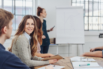 Young woman seated in a business presentation