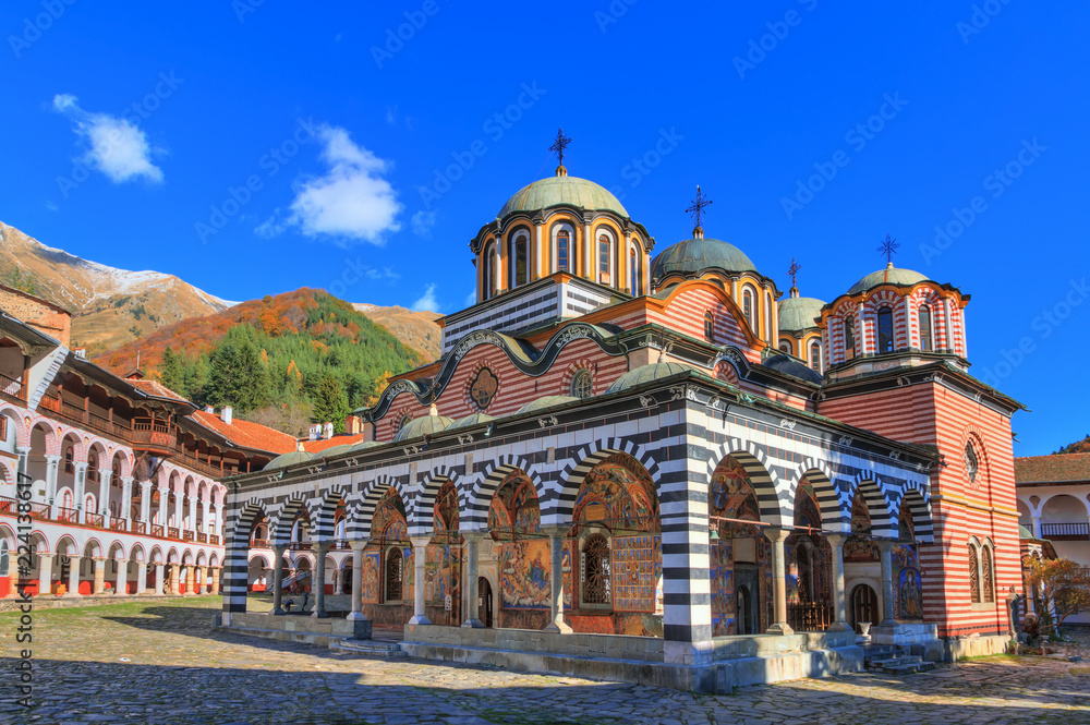 Beautiful view of the Orthodox Rila Monastery, a famous tourist attraction and cultural heritage monument in the Rila Nature Park mountains in Bulgaria - obrazy, fototapety, plakaty 