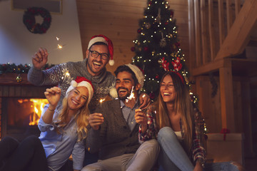 Canvas Print - Friends waving with sparklers on midnight New Year countdown