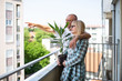 © Dusko - Middle aged couple standing on their new apartment terrace and enjoying in beautiful view. Real estate and moving theme.