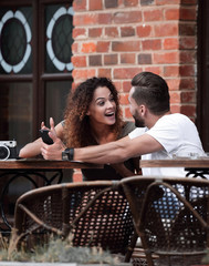 Sticker - Portrait of a young  couple sitting down at a cafe terrace