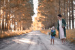 © alexkich - Mother with daughter walking on a road