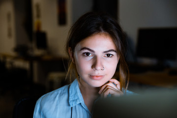 Wall Mural - Young woman graphic designer using pc computer working at night in office.