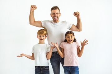 Wall Mural - The father and kids gesturing on the white background