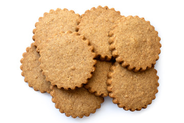 Poster - A pile of round gingerbread biscuits isolated on white from above. Serrated edge.