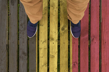 man stepped on a flag of Belgium painted on a wooden floor