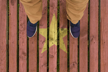 man stepped on a flag of Vietnam painted on a wooden floor