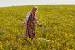 © Dmitrii - a girl in a Russian folk costume walks the field in a warm autumn afternoon