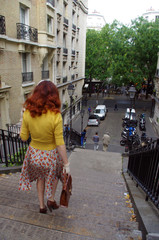 Wall Mural - A Parisian woman walks down the stairs in Montmartre in Paris 