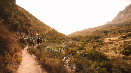 Wall Mural - Extreme rocky terrain in mountains with hikers