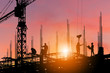 © JU.STOCKER - Silhouette of Engineer and worker on building site, construction site with clipping path at sunset in evening time.