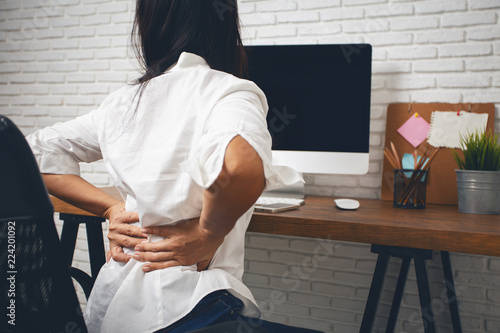 Fotografía Business woman suffering from back pain in office home