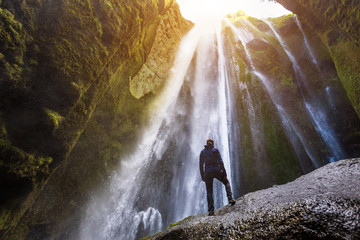 Gljufrabui waterfall in South Iceland,  adventurous traveller standing in front of the stream cascading into the gorge or canyon, hidden Icelandic landmark, inspirational landscape