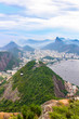 View of city Rio de Janeiro with Favelas in the hills with misty statue on mountain