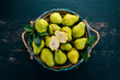 Fresh green pear. Assortment of pears in a wooden box. On the black table. Free space for text. Top view.