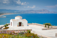 Traditional Small Whitewash Greek Orthodox Chapel On The Edge Of Aegean Sea.