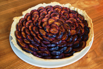 Wall Mural - Plum Pie Right Out The Oven On A With Plate On A Wooden Table