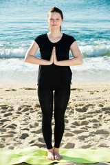 Wall Mural - Girl in black T-shirt is staying and doing meditation