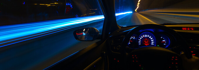 Movement of the car at night at a speed view from the interior, Brilliant road with lights with a car at high speed