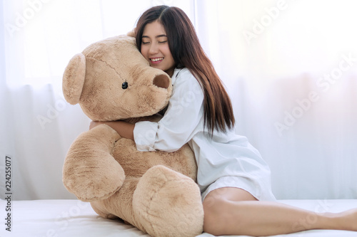 girl hugging big teddy bear