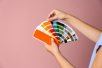 Poster - Female interior designer with palette samples on color background, closeup. Space for text