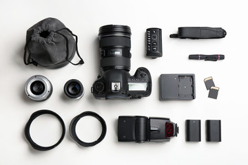 Wall Mural - flat lay composition with photographer's equipment and accessories on white background