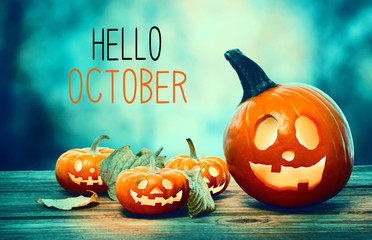 hello october with pumpkins on a spooky forest at night