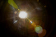solar lens flare over black background