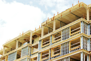 Contruction site of residential building on blue sky background