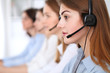 © rogerphoto - Call center. Beautiful cheerful smiling operator consulting clients with headset. Business concept of customer service