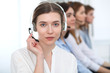 © rogerphoto - Call center. Beautiful cheerful smiling operator consulting clients with headset. Business concept of customer service