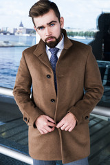 Wall Mural - The man with a beard, poses in a business suit