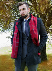 Wall Mural - The man with a beard, poses in a business suit