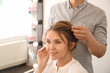 © Pixel-Shot - Professional hairdresser working with client in beauty salon