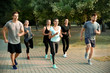 © Pixel-Shot - Group of sporty people running outdoors
