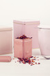 Different pink tea containers with fruit tea