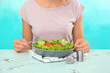 © Pixel-Shot - Woman eating fresh salad with salmon at table